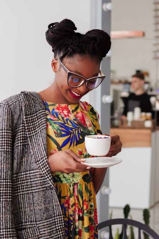woman standing holding coffee mug
